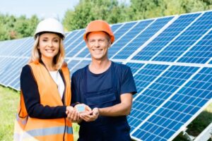 people holding hands in front of solar panels